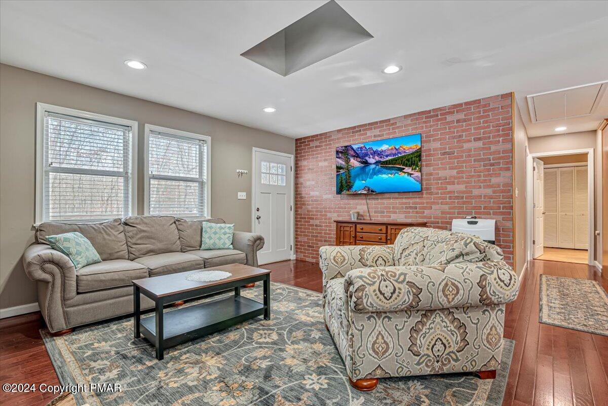 124 Rabbit Court Bushkill, PA 18324 - Photo 11 of 44 a living room with furniture a rug and a flat screen tv