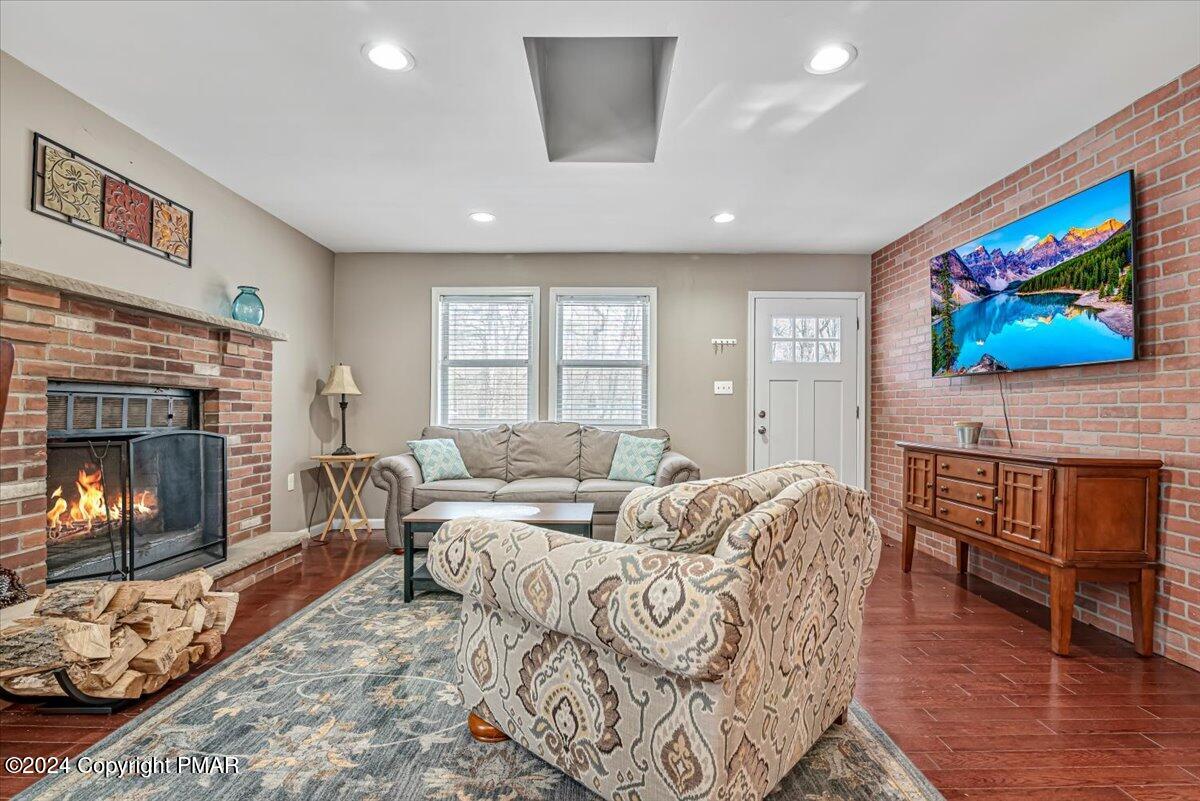 124 Rabbit Court Bushkill, PA 18324 - Photo 12 of 44 a living room with furniture a fireplace and a flat screen tv
