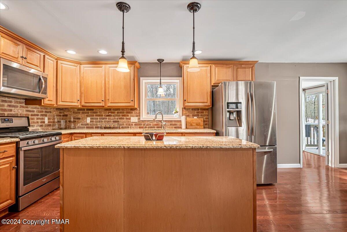 124 Rabbit Court Bushkill, PA 18324 - Photo 16 of 44 a kitchen with stainless steel appliances granite countertop a sink a stove and a refrigerator