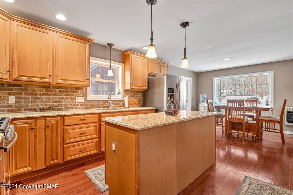 124 Rabbit Court Bushkill, PA 18324 - Photo 42 of 44 a kitchen with stainless steel appliances granite countertop sink stove and wooden cabinets