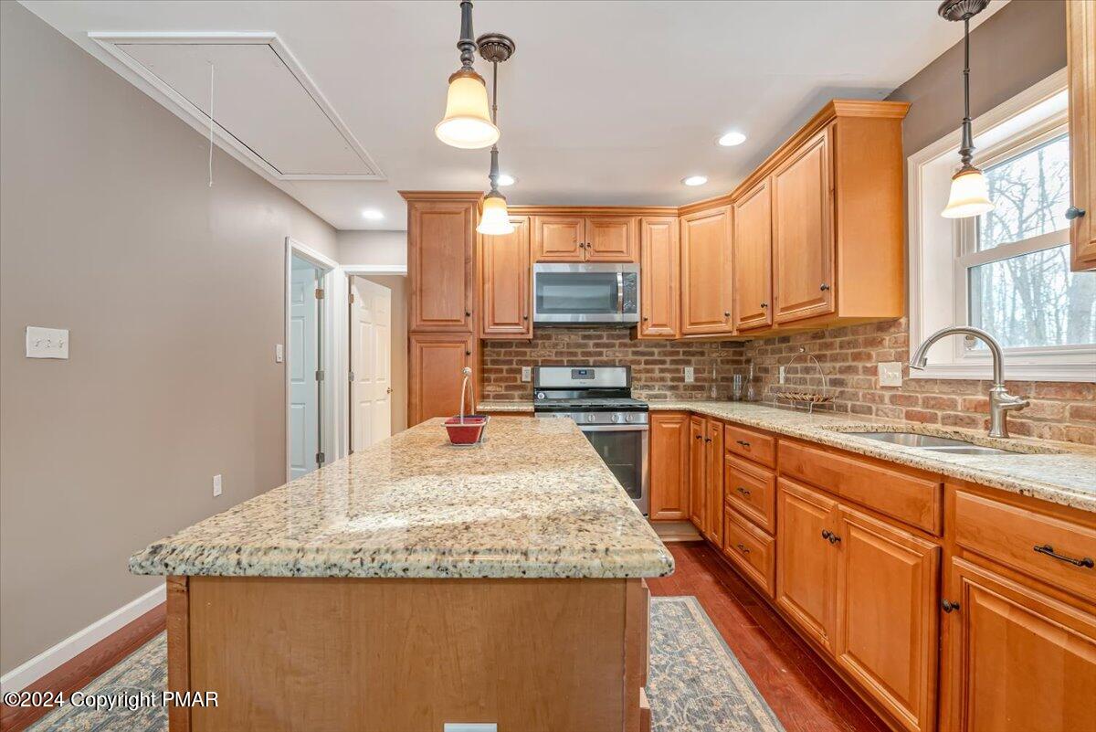 124 Rabbit Court Bushkill, PA 18324 - Photo 17 of 44 a kitchen with stainless steel appliances granite countertop a sink stove and cabinets