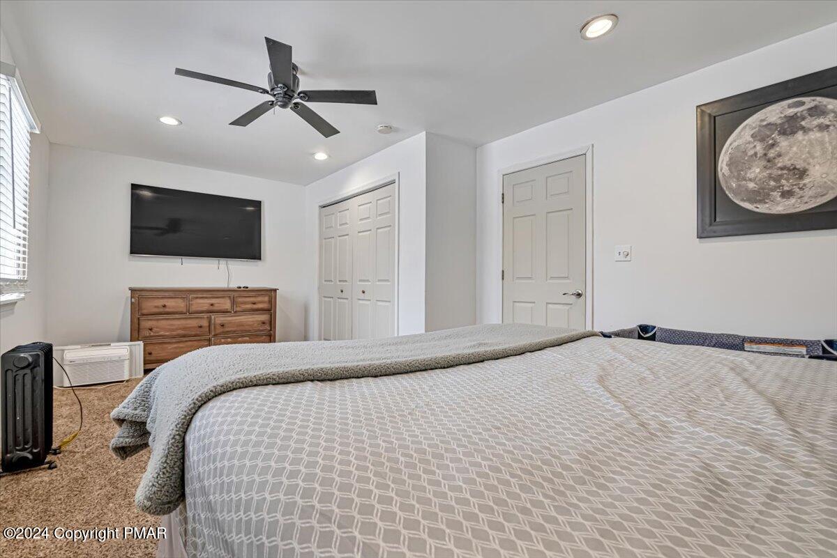 124 Rabbit Court Bushkill, PA 18324 - Photo 19 of 44 a bedroom with a large bed and a flat screen tv