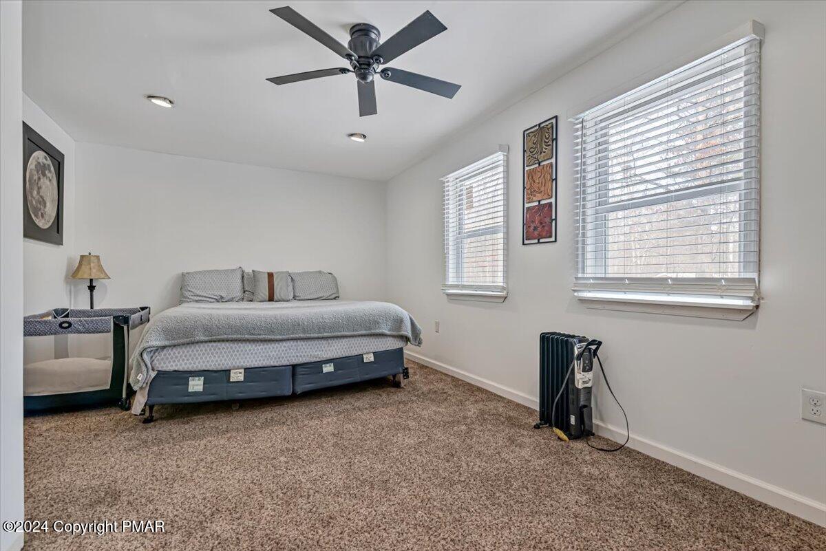 124 Rabbit Court Bushkill, PA 18324 - Photo 20 of 44 a spacious bedroom with a bed and a window