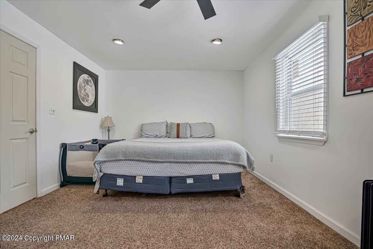 124 Rabbit Court Bushkill, PA 18324 - Photo 21 of 44 a spacious bedroom with a bed and a window
