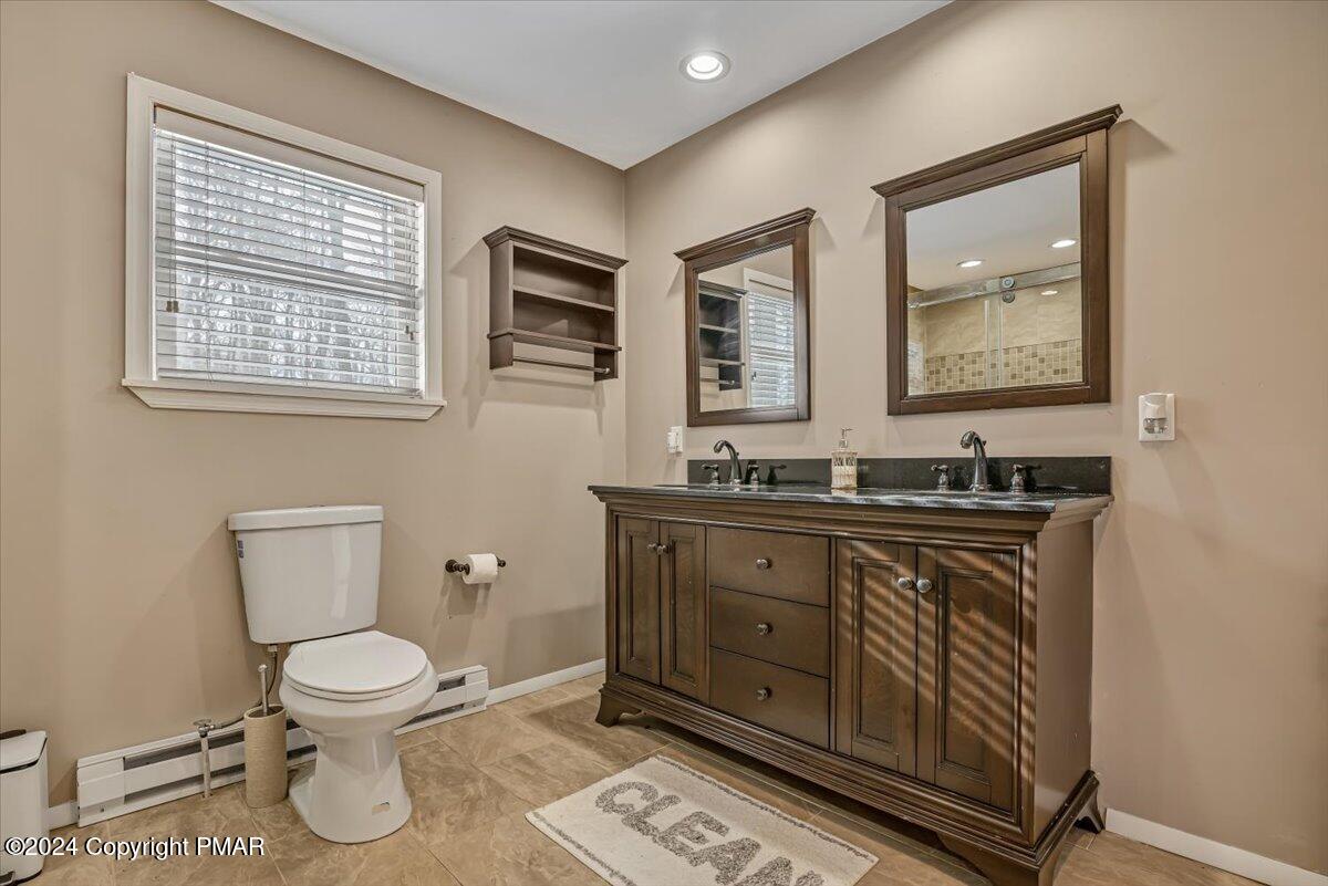 124 Rabbit Court Bushkill, PA 18324 - Photo 23 of 44 a bathroom with a toilet a sink and mirror