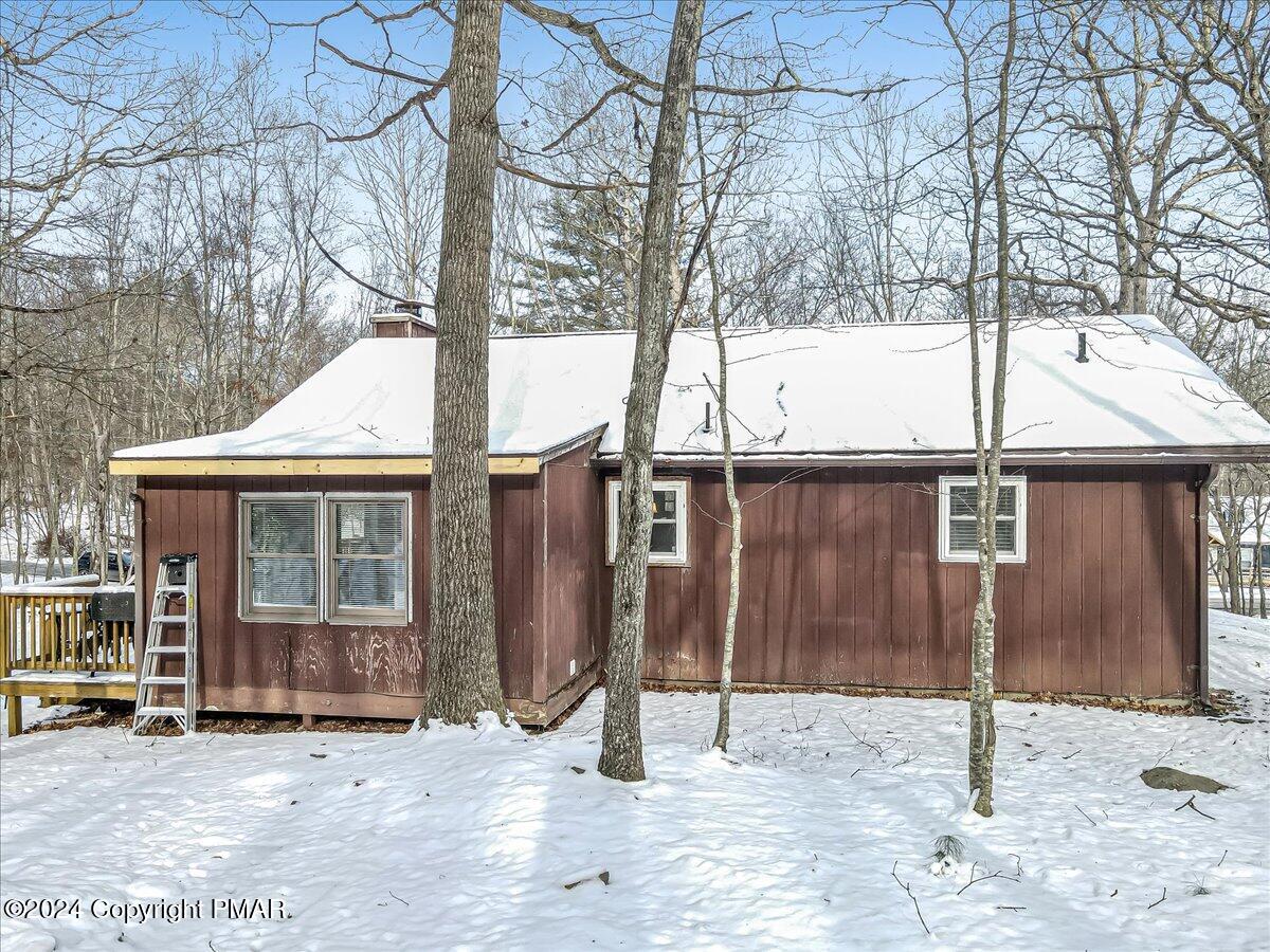 124 Rabbit Court Bushkill, PA 18324 - Photo 28 of 44 a backyard of a house with glass door and an outdoor space