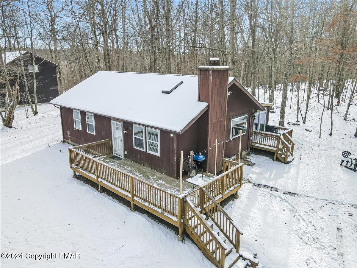 124 Rabbit Court Bushkill, PA 18324 - Photo 32 of 44 a view of a roof deck with wooden fence and a couple of chairs