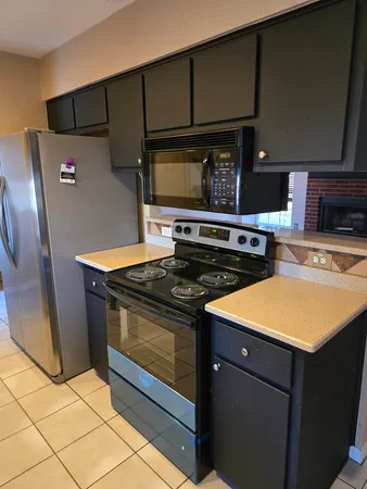 a stove top oven sitting inside of a kitchen