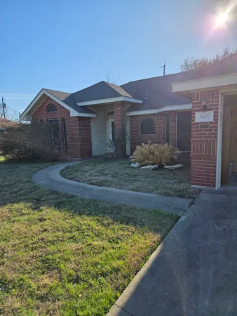 a view of a house with a small yard