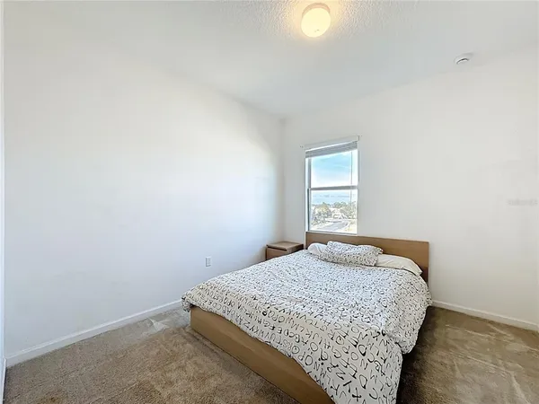a bedroom with a bed and window