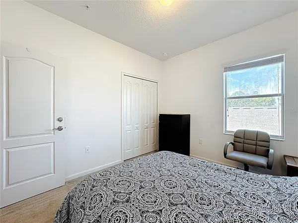 a bedroom with a bed and a dresser