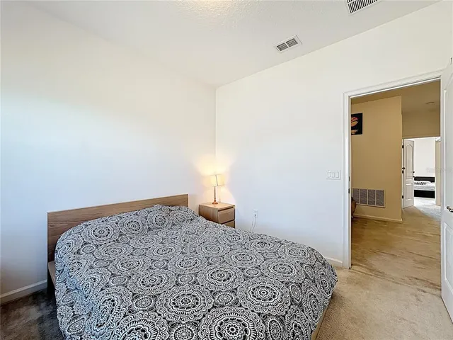 a bedroom with a bed and a table in it