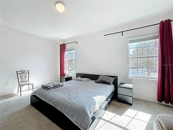 a bedroom with a bed and a window