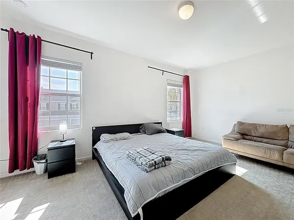 a bedroom with a bed and a couch