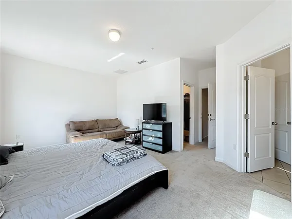 a bedroom with a bed and a television