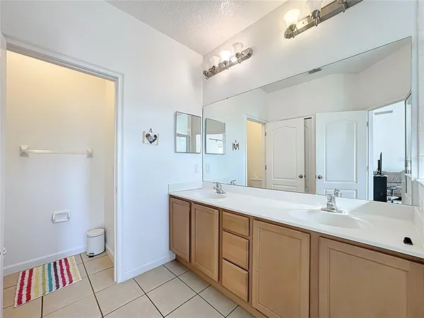 a bathroom with a sink a mirror and a shower