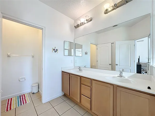 a bathroom with a sink a mirror and a shower