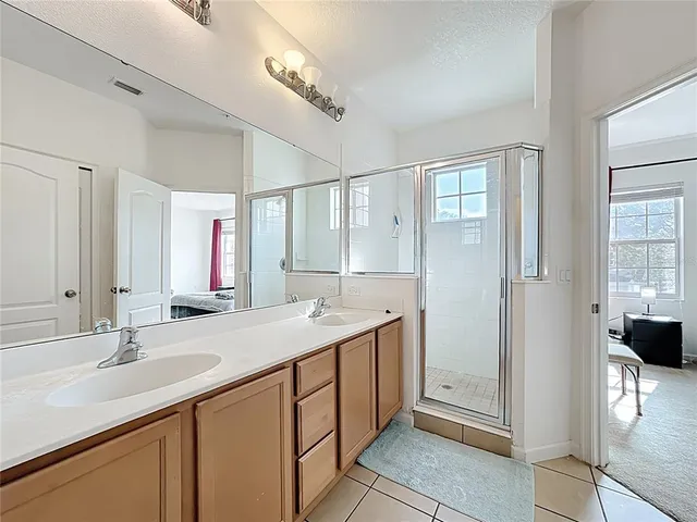 a bathroom with a double vanity sink a and mirror