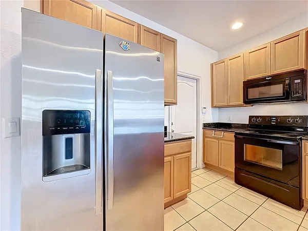 a kitchen with stainless steel appliances a stove a microwave and a refrigerator