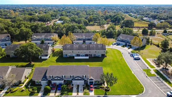 a aerial view of a swimming pool with a yard and seating area