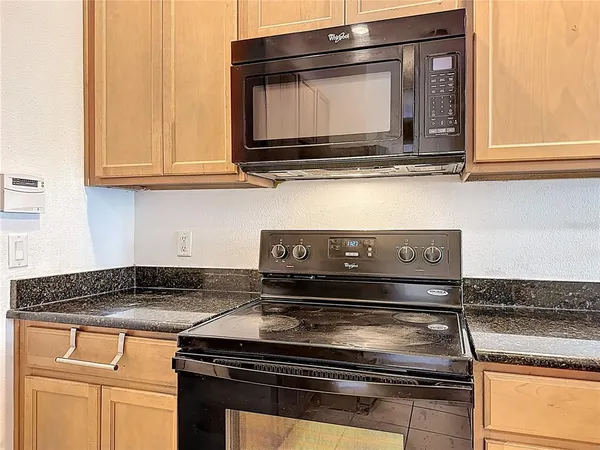 a stove top oven sitting inside of a kitchen
