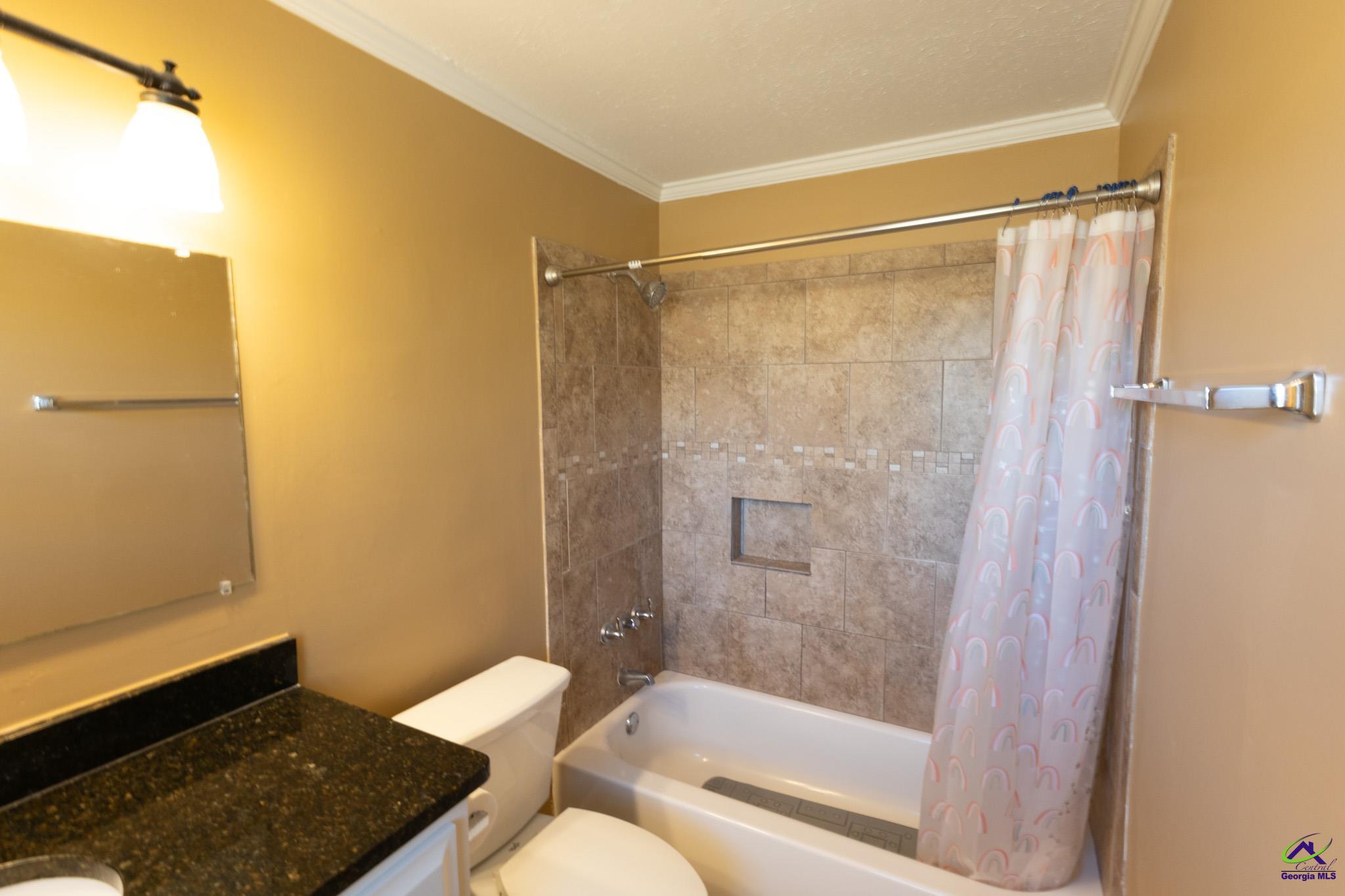 3491 Sandy Circle Macon, GA 31216 - Photo 25 of 47 a bathroom with a shower curtain and a sink