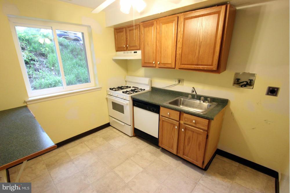 3934 Bel Pre Road, Unit 1 Silver Spring, MD 20906 - Photo 7 of 12 a kitchen with stainless steel appliances granite countertop white cabinets a stove a sink and dishwasher