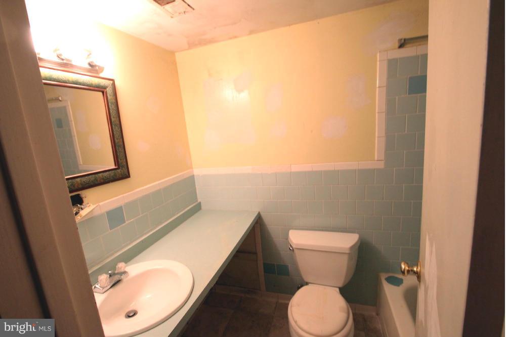 3934 Bel Pre Road, Unit 1 Silver Spring, MD 20906 - Photo 8 of 12 a bathroom with a toilet and a mirror