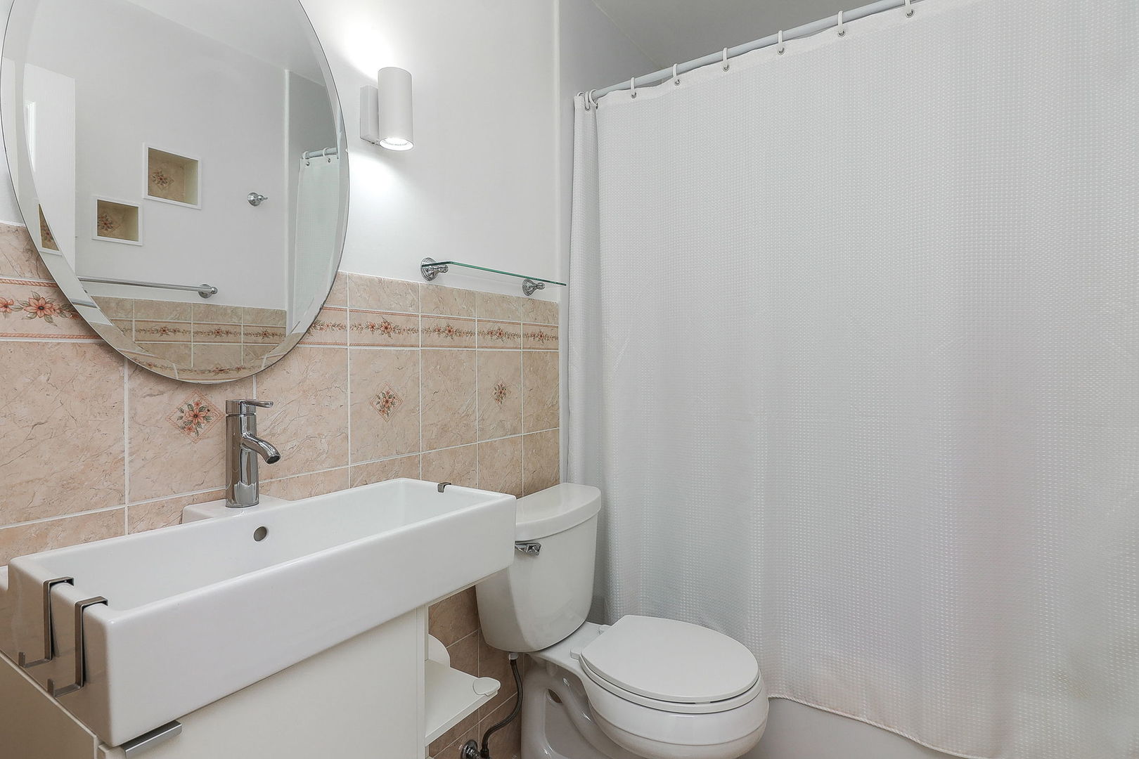 201 North Waters Edge Drive, Unit 302 Glendale Heights, IL 60139 - Photo 13 of 18 a bathroom with a sink a toilet and shower