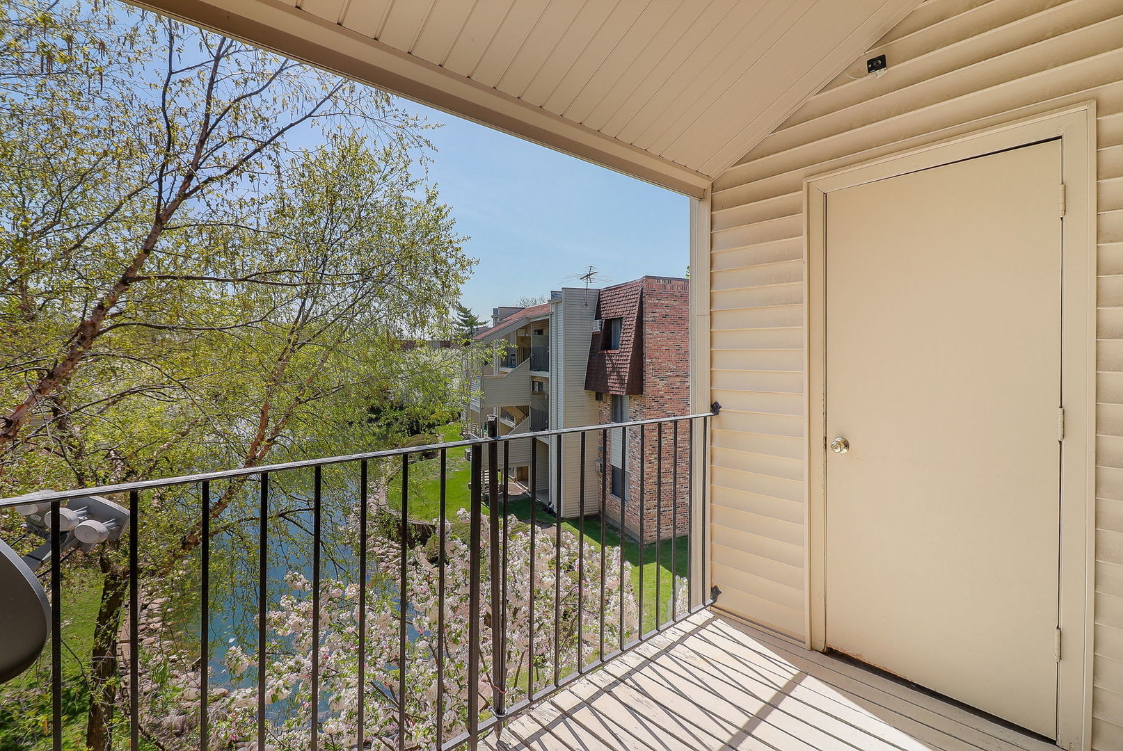 201 North Waters Edge Drive, Unit 302 Glendale Heights, IL 60139 - Photo 15 of 18 a view of balcony with wooden floor and fence