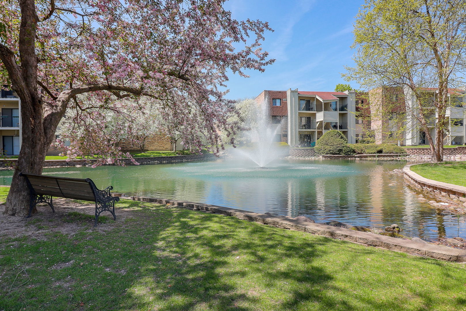 201 North Waters Edge Drive, Unit 302 Glendale Heights, IL 60139 - Photo 17 of 18 a lake view with a bench next to a lake