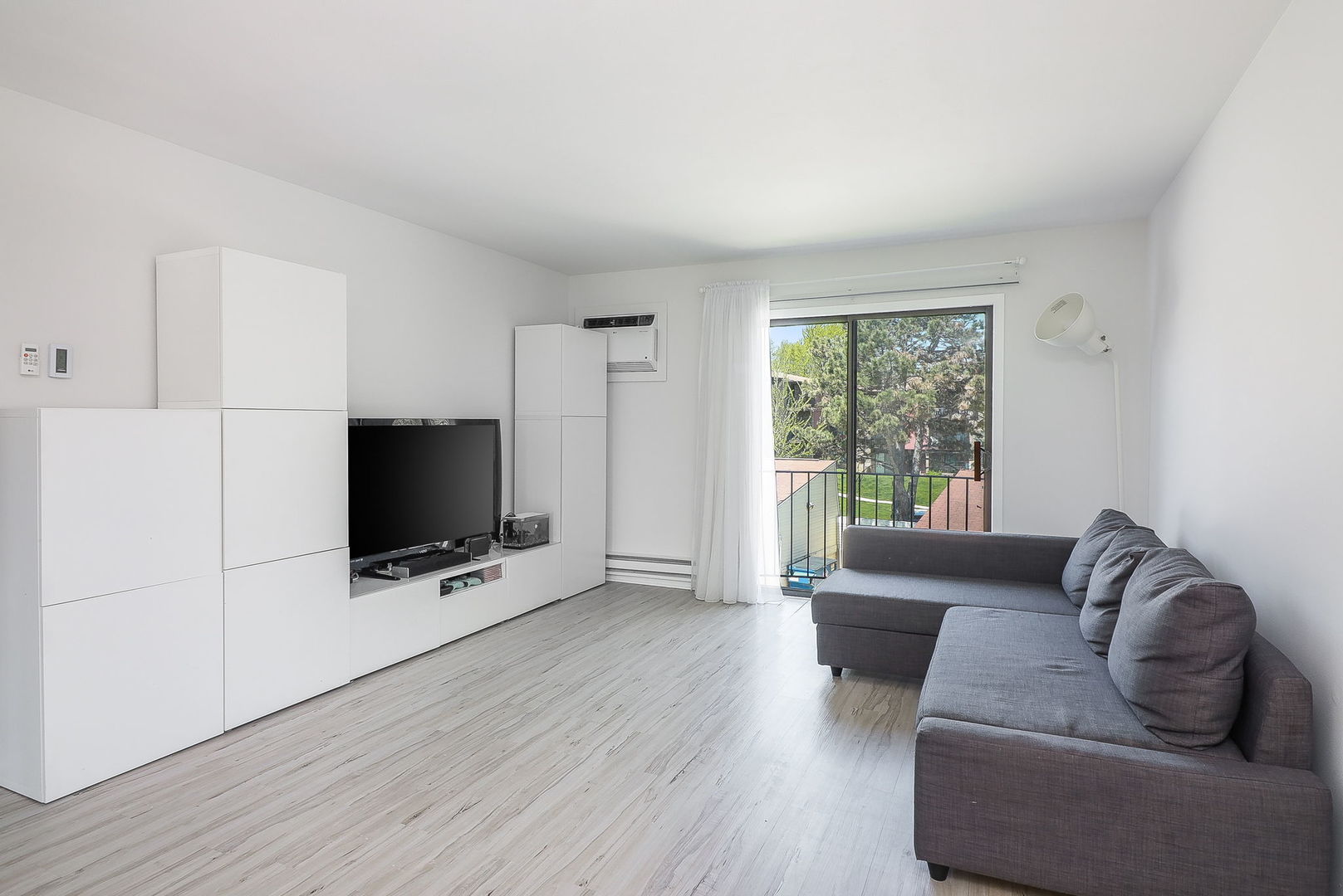 201 North Waters Edge Drive, Unit 302 Glendale Heights, IL 60139 - Photo 2 of 18 a living room with furniture and a flat screen tv