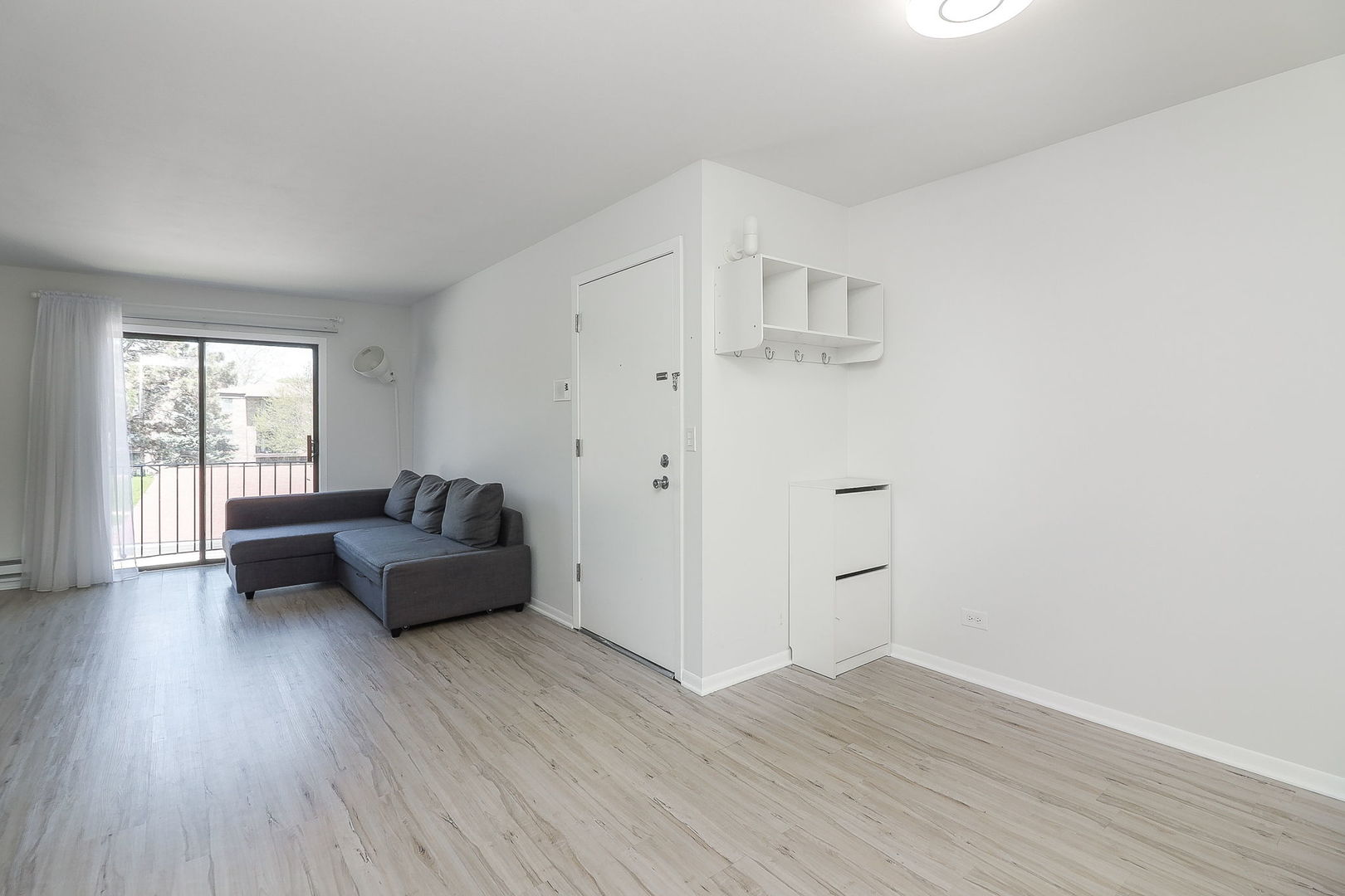 201 North Waters Edge Drive, Unit 302 Glendale Heights, IL 60139 - Photo 5 of 18 a living room with furniture and wooden floor