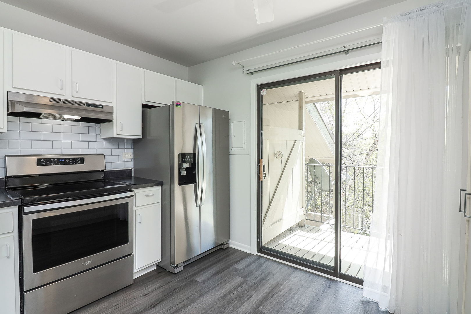 201 North Waters Edge Drive, Unit 302 Glendale Heights, IL 60139 - Photo 7 of 18 a kitchen with stainless steel appliances a stove sink and refrigerator