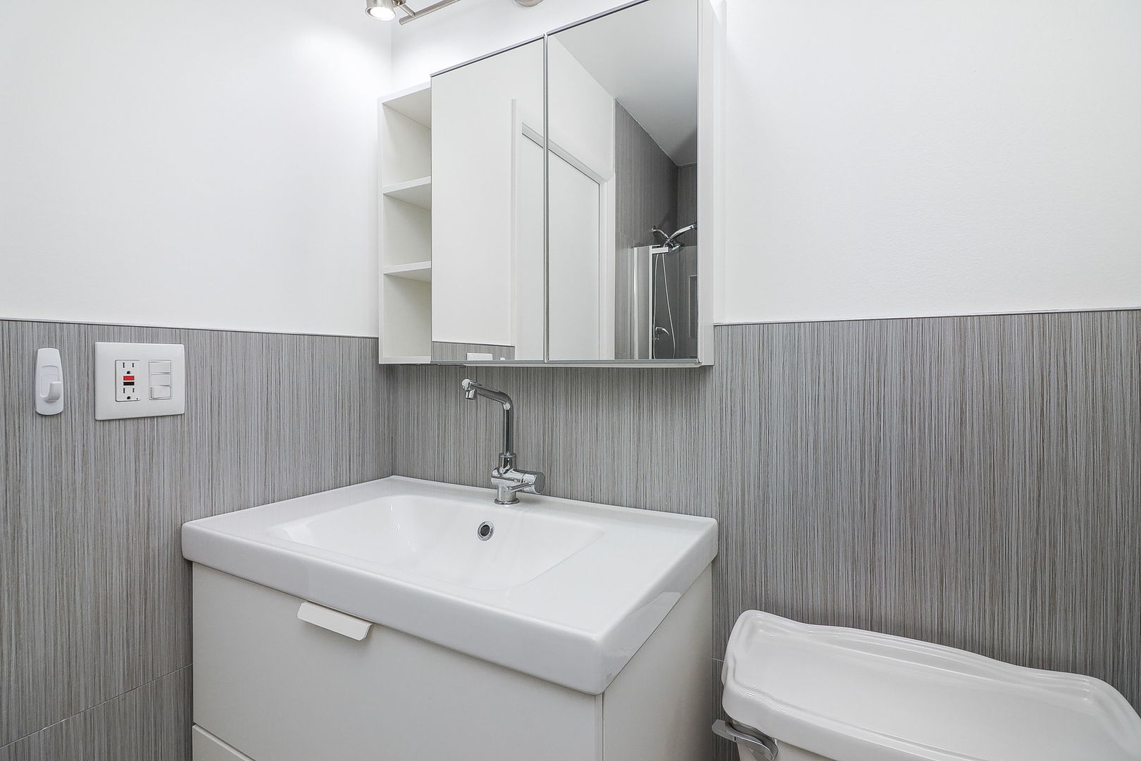 201 North Waters Edge Drive, Unit 302 Glendale Heights, IL 60139 - Photo 10 of 18 a bathroom with a sink a toilet and mirror