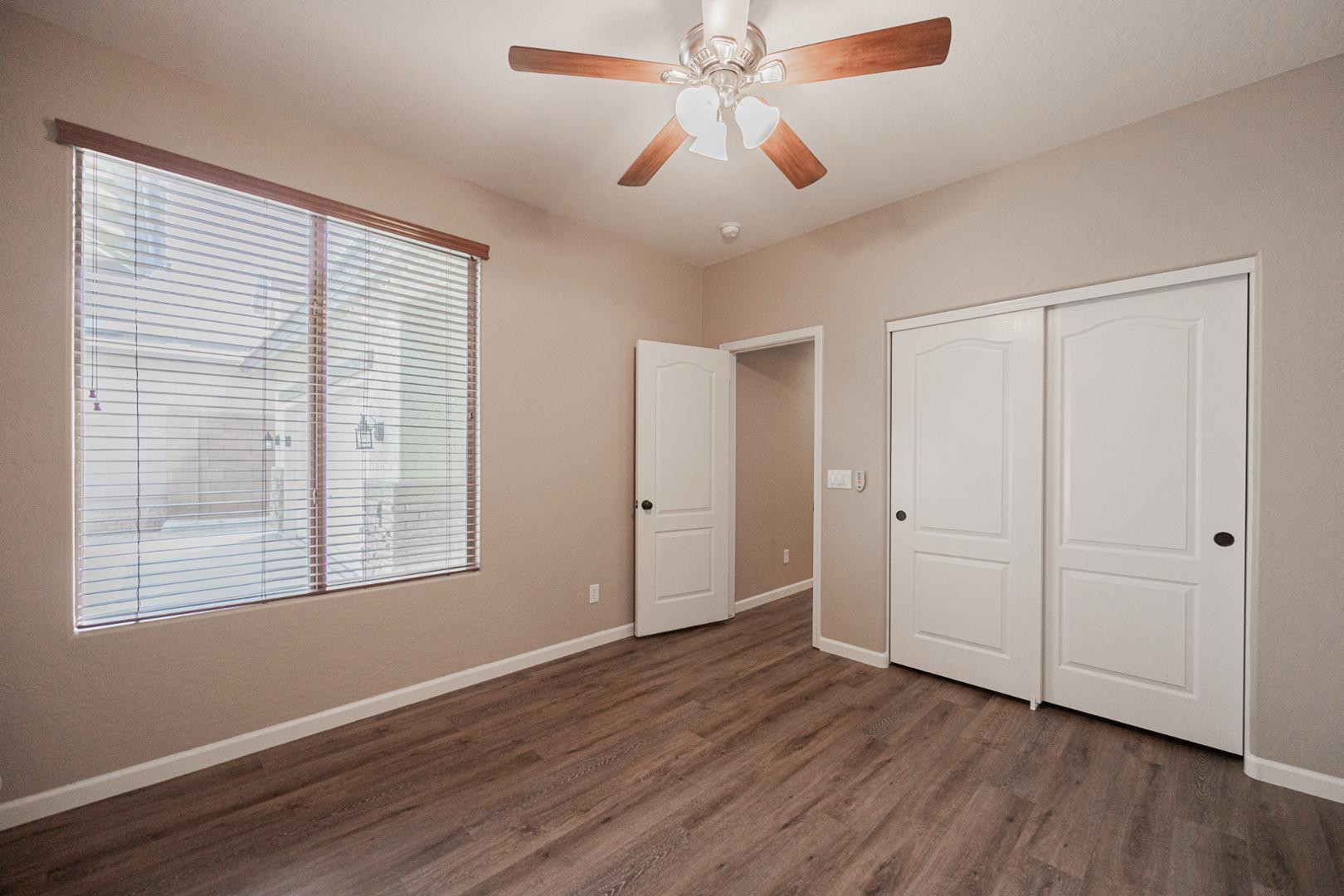 6539 West Jomax Road Phoenix, AZ 85083 - Photo 28 of 39 a view of an empty room with wooden floor and a window