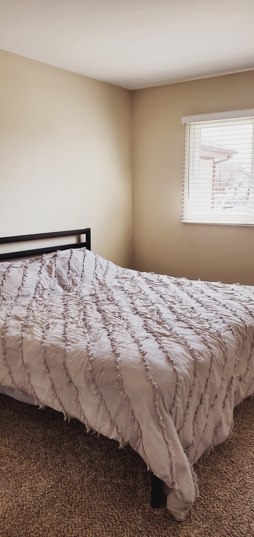 660 Niagara Drive Bolingbrook, IL 60440 - Photo 22 of 28 a bedroom with a bed and window