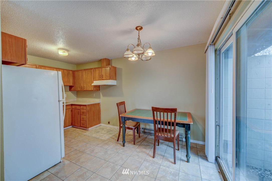 8701-8703 Custer Road Southwest Lakewood, WA 98499 - Photo 12 of 17 a dining room with a wooden table and chairs