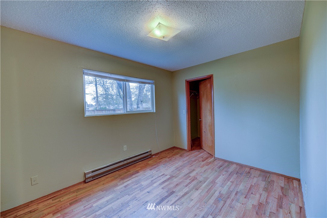8701-8703 Custer Road Southwest Lakewood, WA 98499 - Photo 15 of 17 an empty room with wooden floor and windows