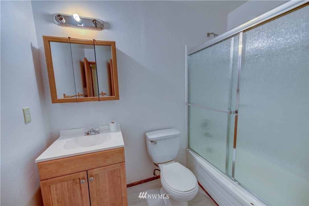 8701-8703 Custer Road Southwest Lakewood, WA 98499 - Photo 16 of 17 a bathroom with a toilet a sink and shower