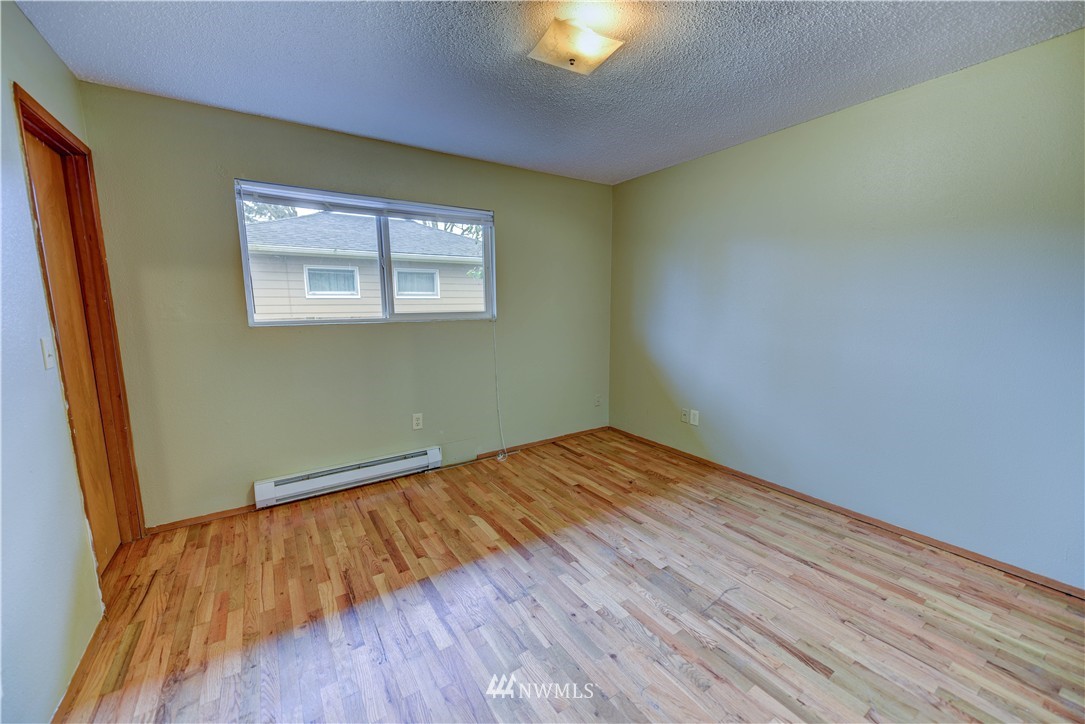 8701-8703 Custer Road Southwest Lakewood, WA 98499 - Photo 17 of 17 a view of empty room with wooden floor