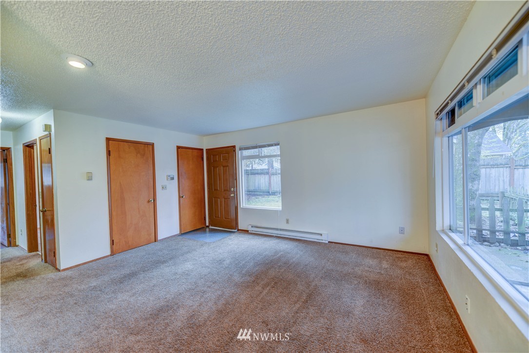 8701-8703 Custer Road Southwest Lakewood, WA 98499 - Photo 4 of 17 a view of an empty room with a window