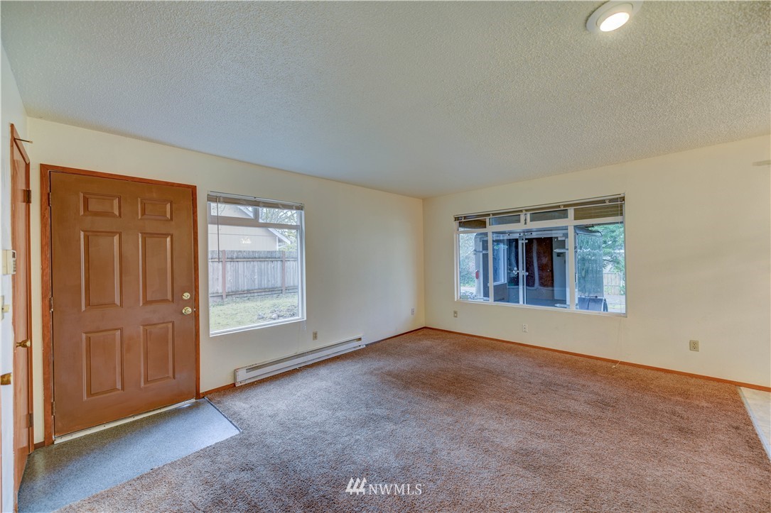 8701-8703 Custer Road Southwest Lakewood, WA 98499 - Photo 5 of 17 an empty room with windows