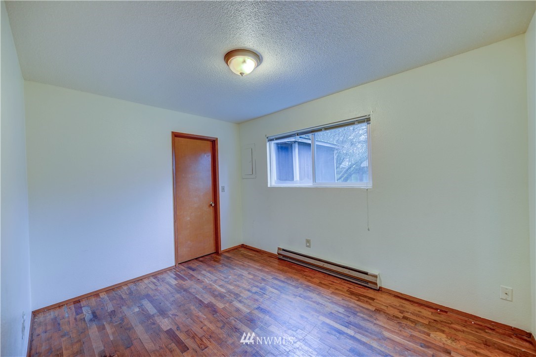 8701-8703 Custer Road Southwest Lakewood, WA 98499 - Photo 6 of 17 a view of empty room with wooden floor