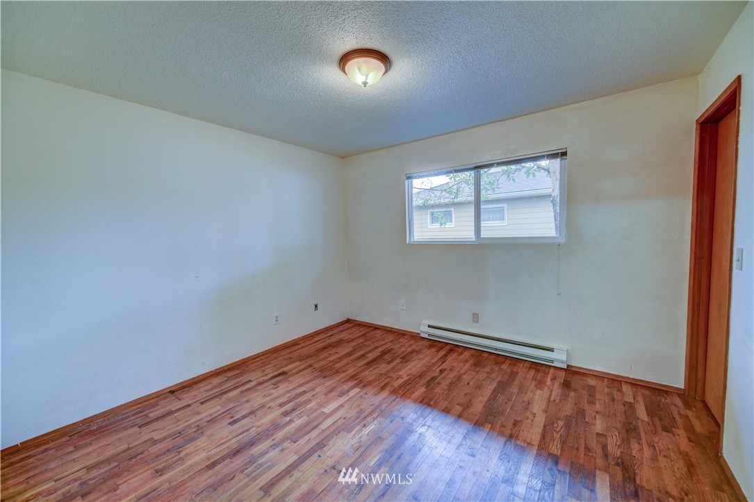 8701-8703 Custer Road Southwest Lakewood, WA 98499 - Photo 8 of 17 an empty room with wooden floor and windows