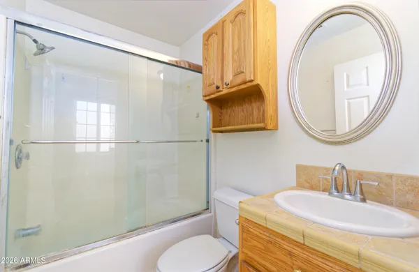 a bathroom with a sink toilet and a mirror