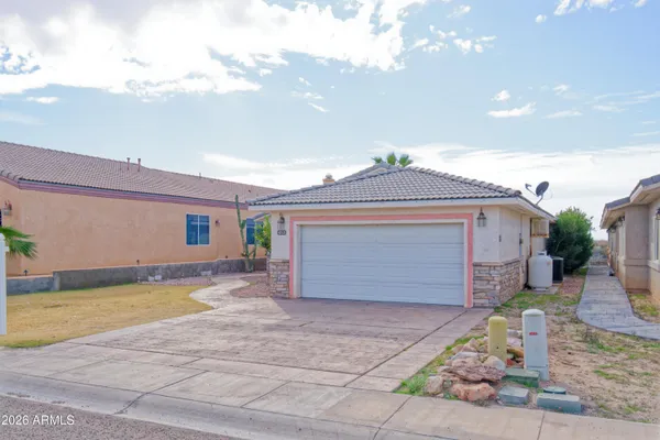 a front view of a house with a yard and garage