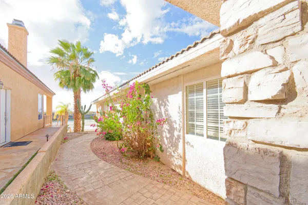 a porch with a table and chairs and potted plants