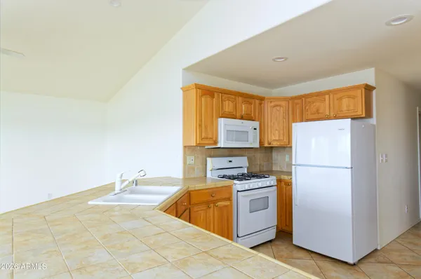 a kitchen with stainless steel appliances a refrigerator and a stove top oven