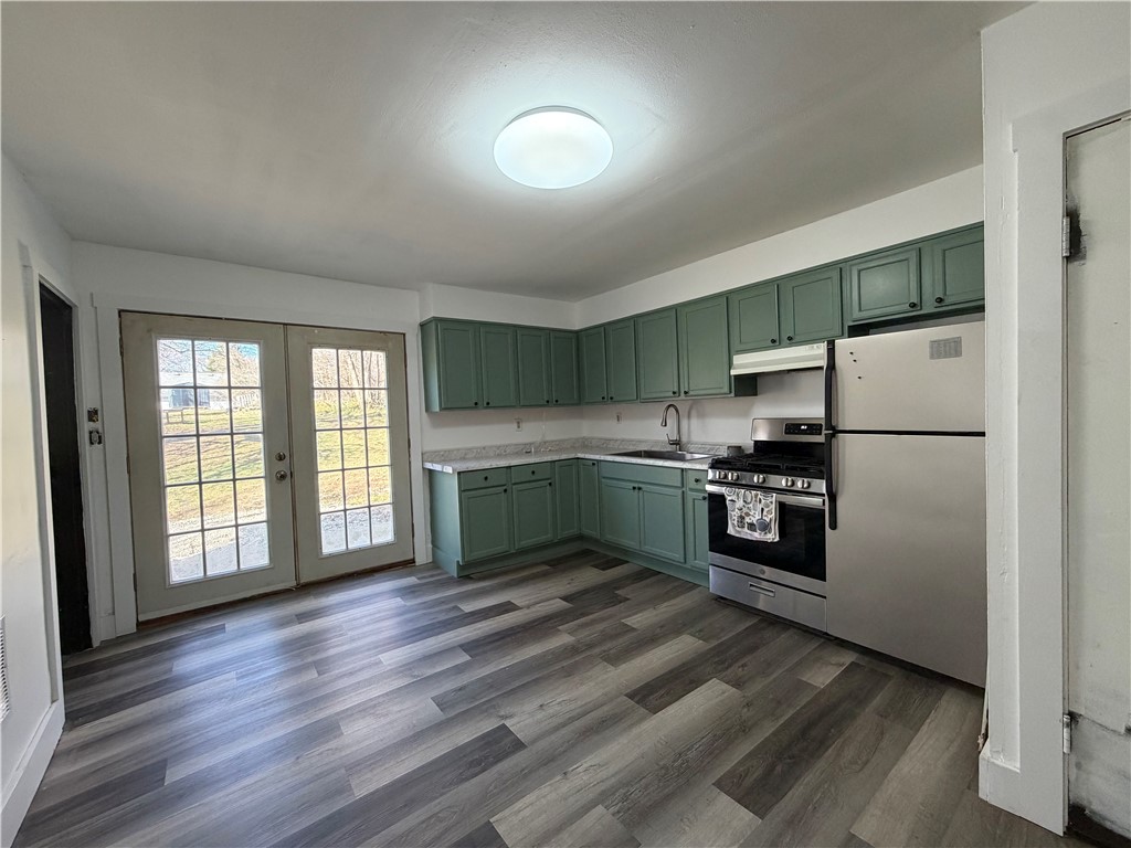 230 West Decatur Street Eaton, OH 45320 - Photo 7 of 22 This bright kitchen features contemporary cabinetry, durable flooring, and direct outdoor access.